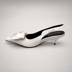 White slingback pump opposite side profile showing a pointed toe and bow detail