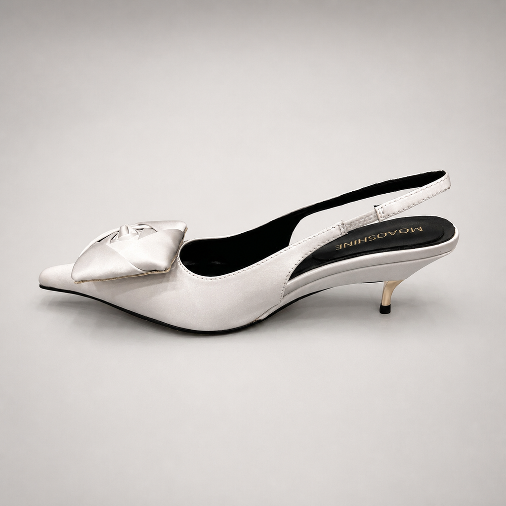 White slingback pump opposite side profile showing a pointed toe and bow detail