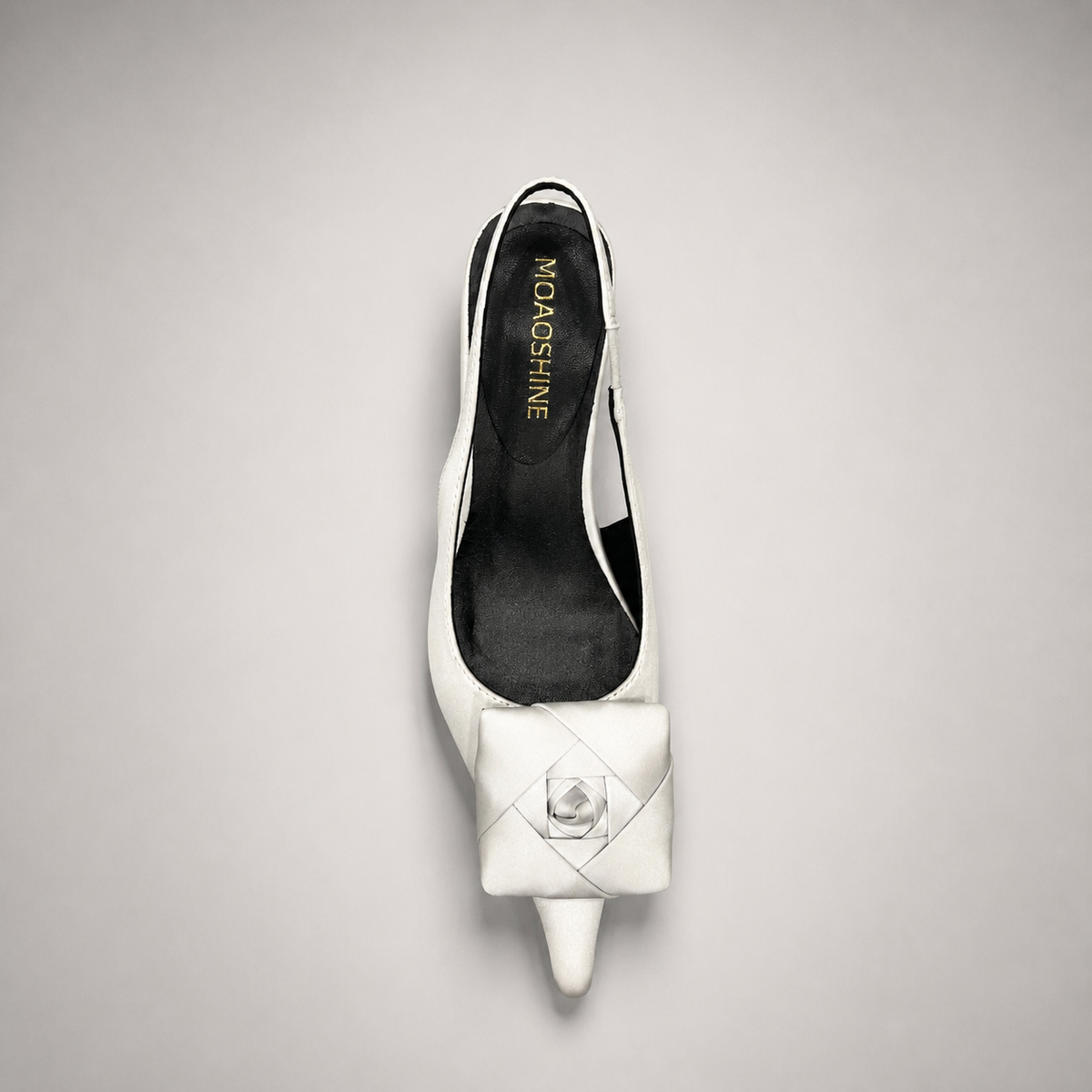 White slingback pump rear view showing a pointed toe and bow detail