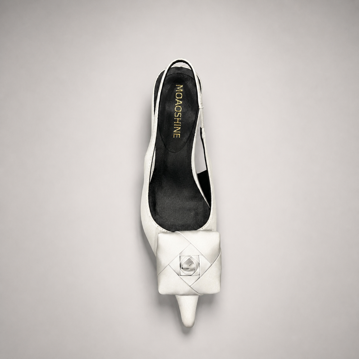 White slingback pump rear view showing a pointed toe and bow detail