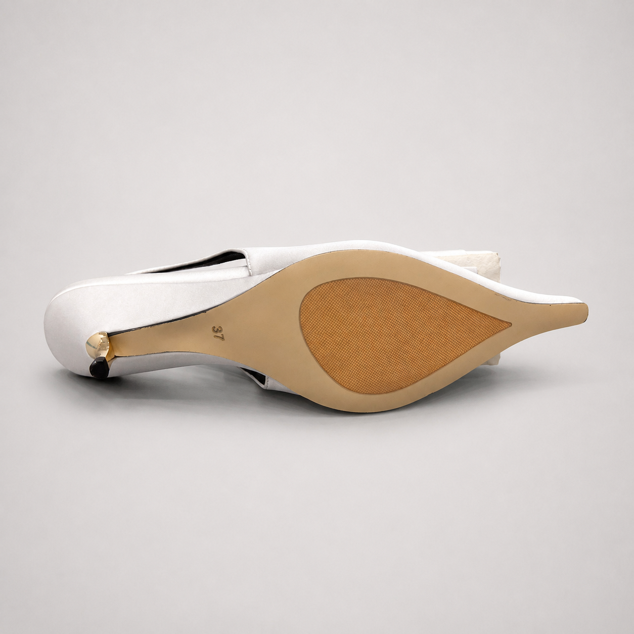 White slingback pump top view showing a pointed toe and bow detail