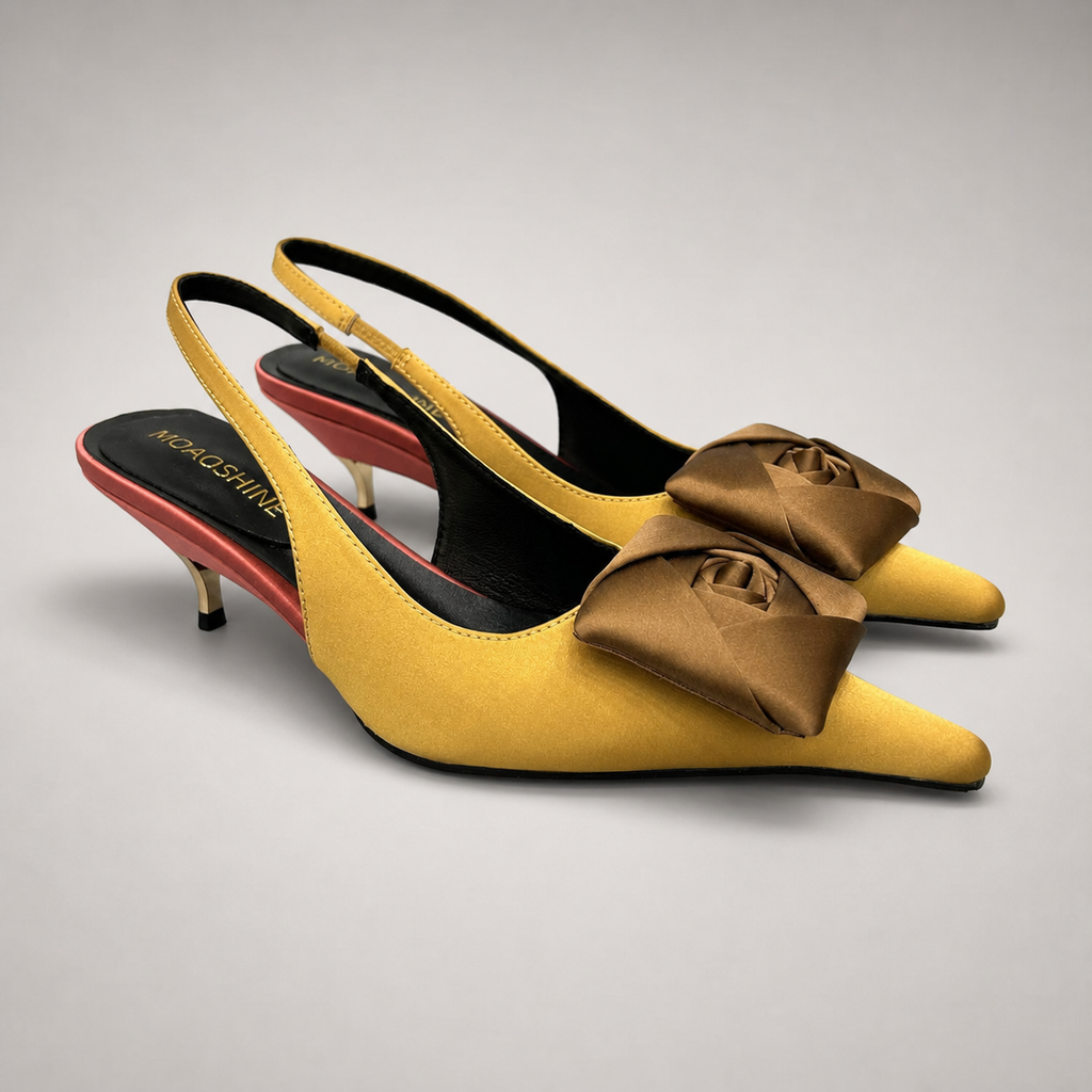 Tan slingback pump pair three-quarter view showing a pointed toe and bow detail