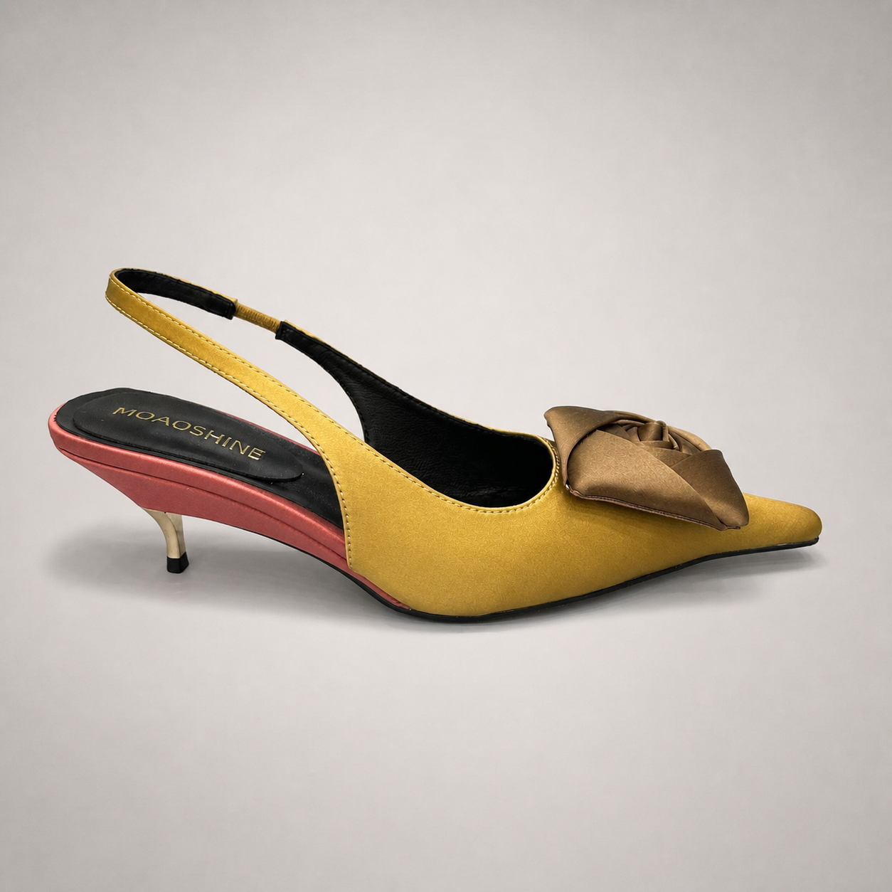 Tan slingback pump side profile showing a pointed toe and bow detail