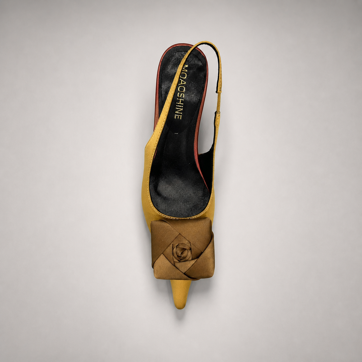 Tan slingback pump top view showing a pointed toe and bow detail