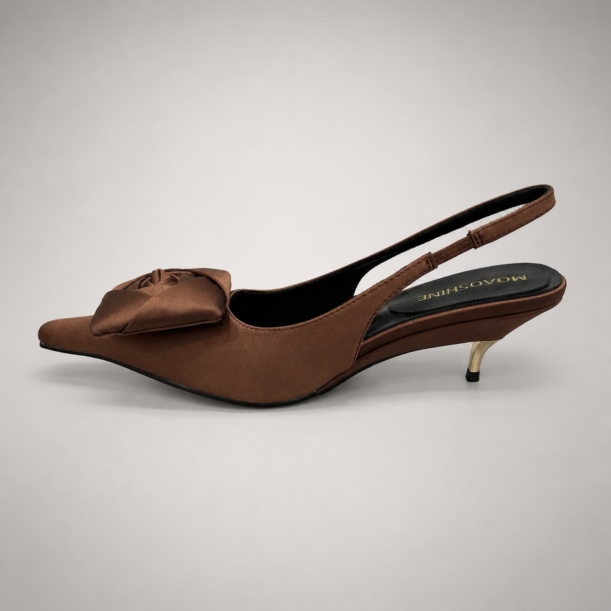 Brown slingback pump opposite side profile showing a pointed toe and bow detail