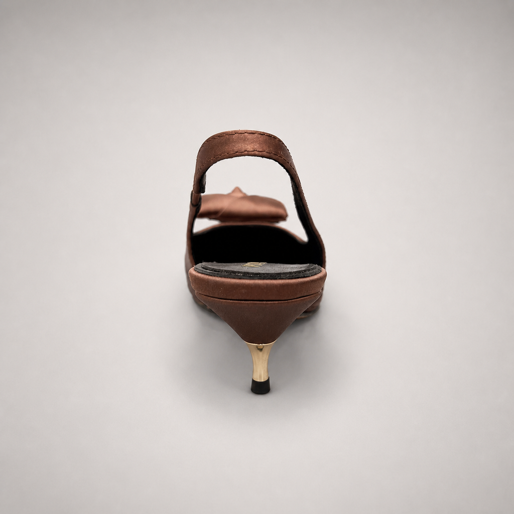Brown slingback pump rear view showing a pointed toe and bow detail