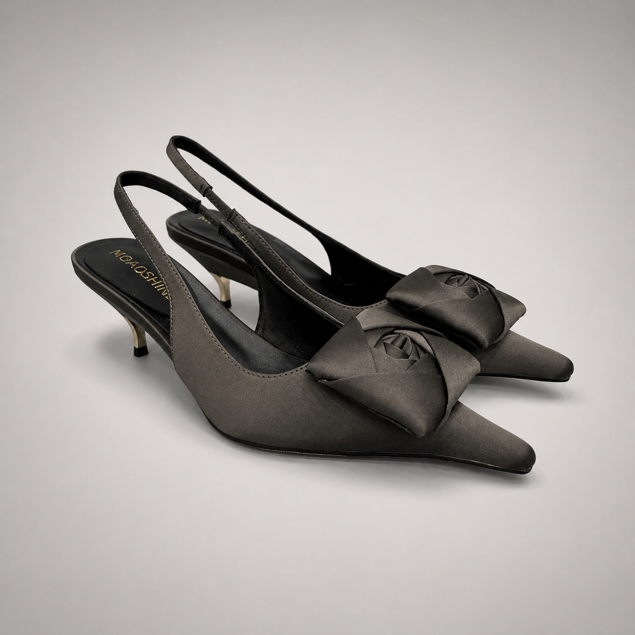 Gray slingback pump pair three-quarter view showing a pointed toe and bow detail