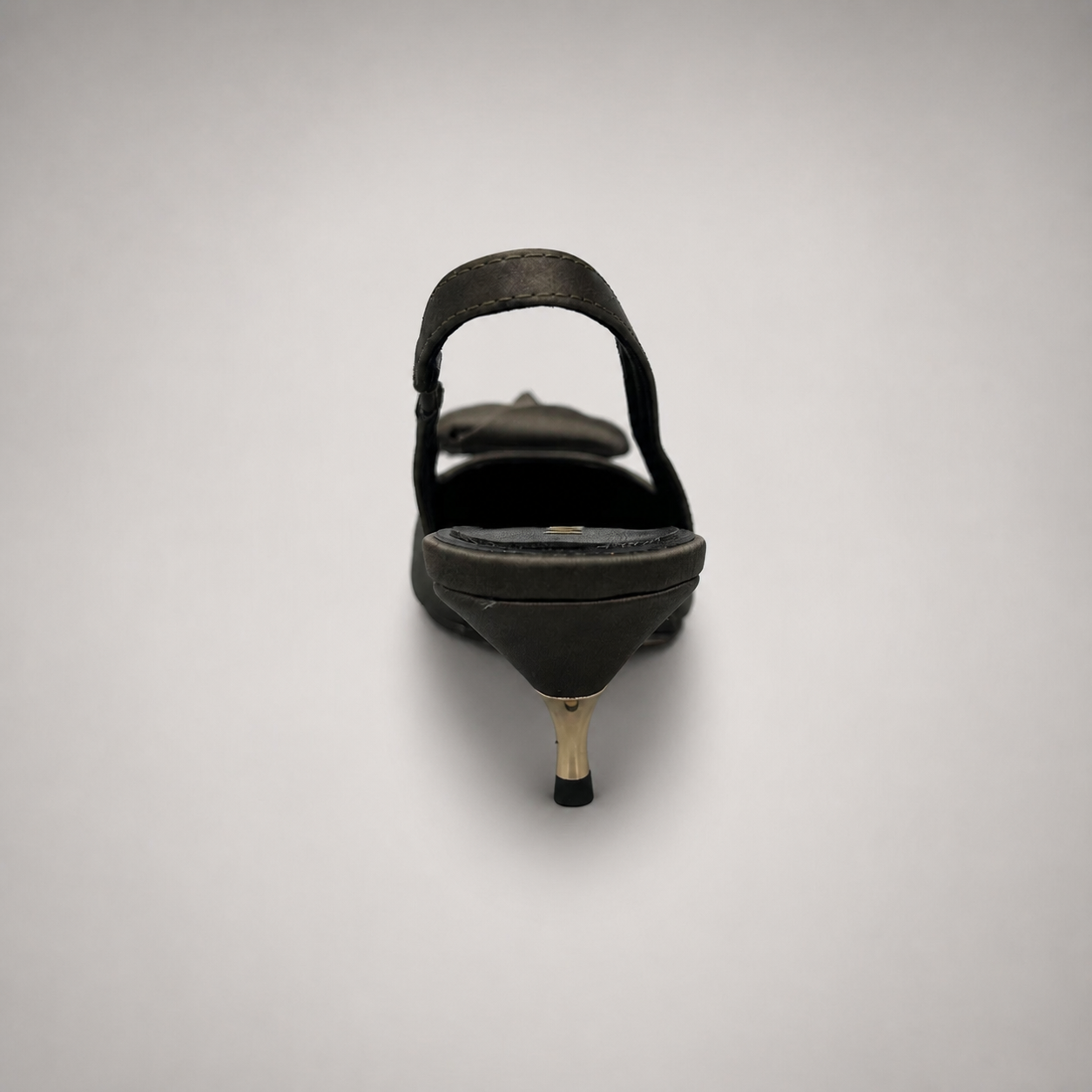 Gray slingback pump rear view showing a pointed toe and bow detail