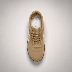Tan soccer shoe second top angle showing a lace-up upper and molded outsole studs