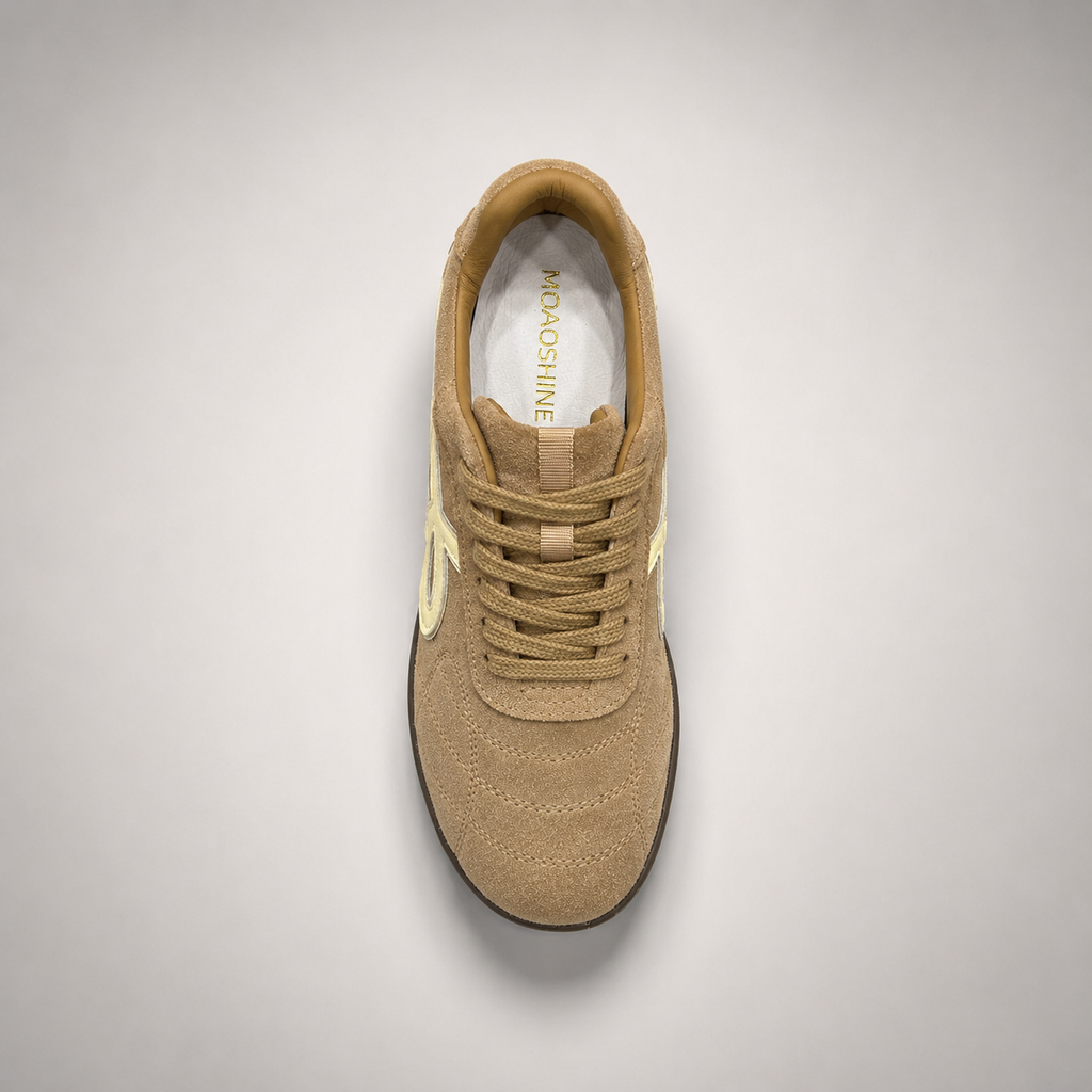 Tan soccer shoe second top angle showing a lace-up upper and molded outsole studs