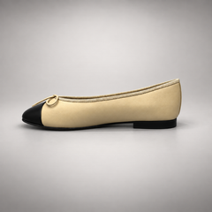 Butter yellow and black cap-toe ballet flats, detail view