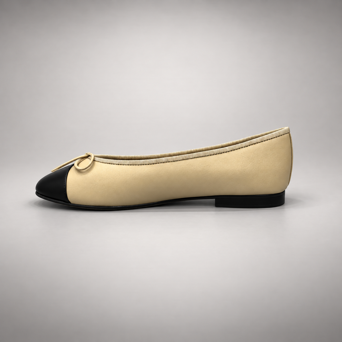 Butter yellow and black cap-toe ballet flats, detail view