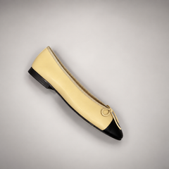 Butter yellow and black cap-toe ballet flats, sole view