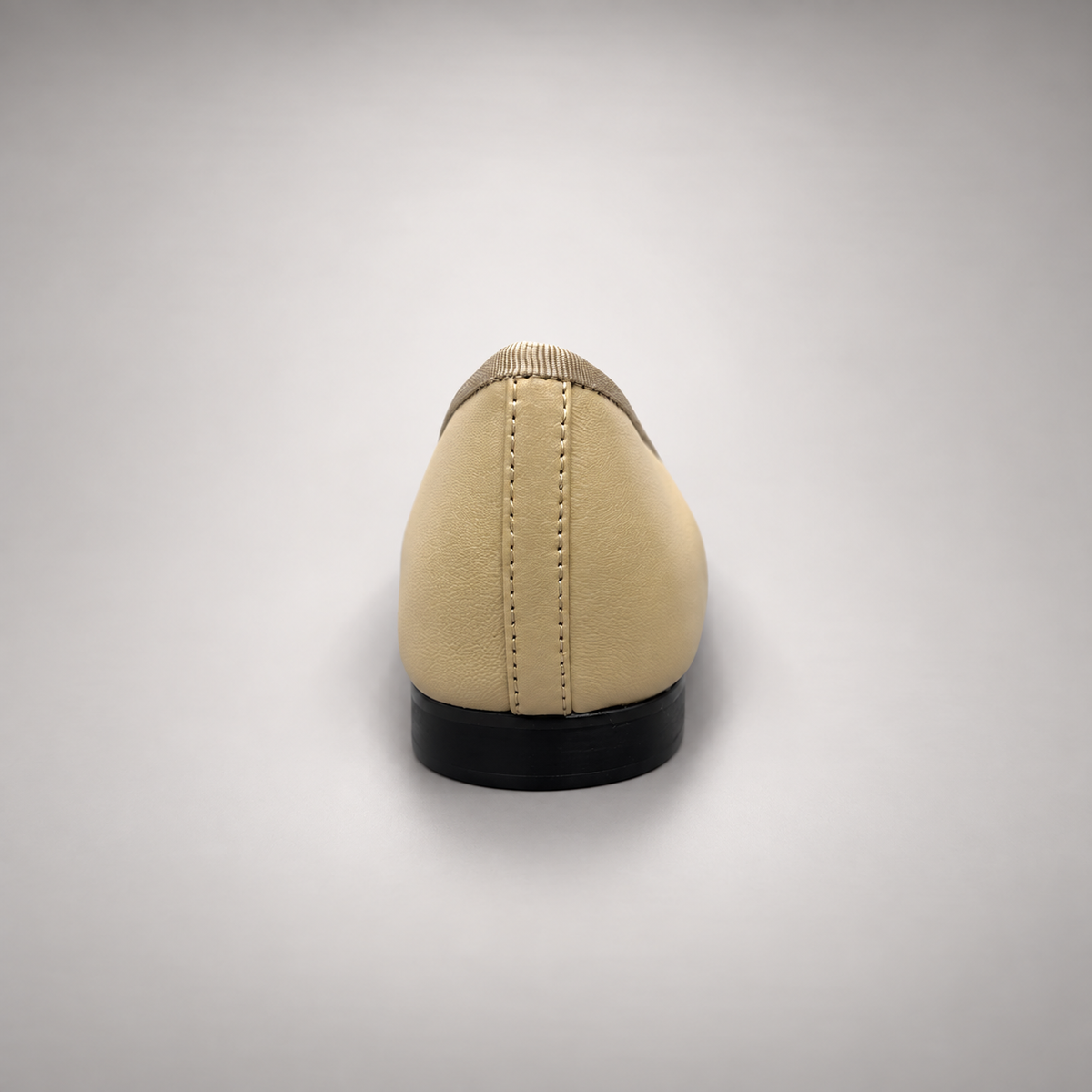 Butter yellow and black cap-toe ballet flats, heel view