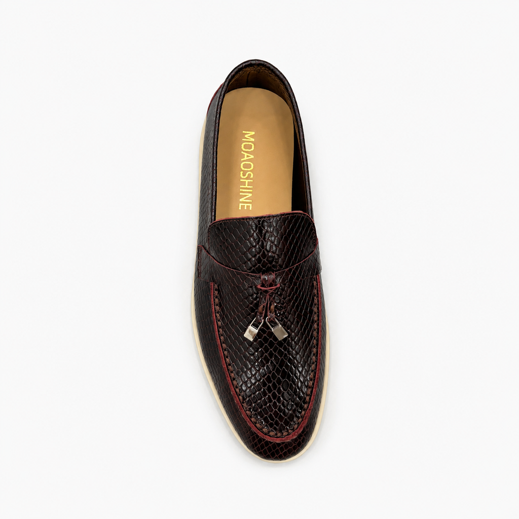 Burgundy loafer top view showing a snakeskin-pattern embossed vamp and tassel detail