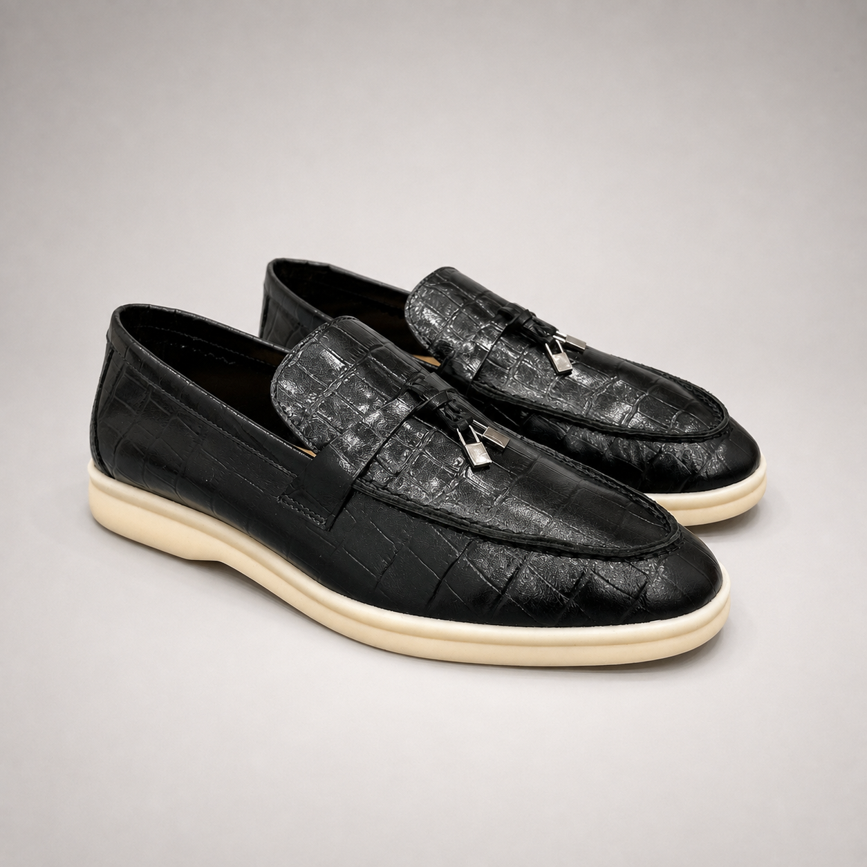 Black loafer second pair angle showing a crocodile-pattern embossed upper and metal accent