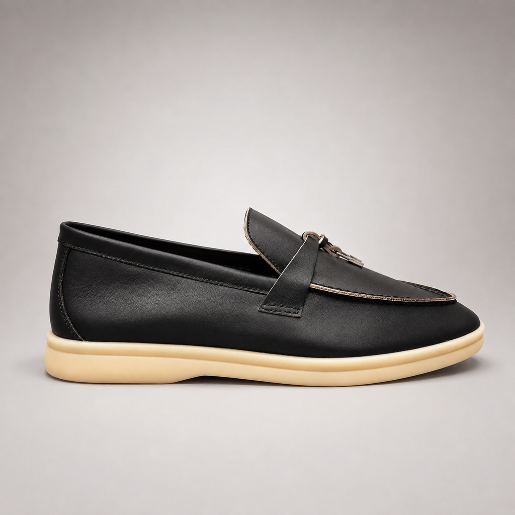 Black loafer side profile showing a metal accent across the vamp