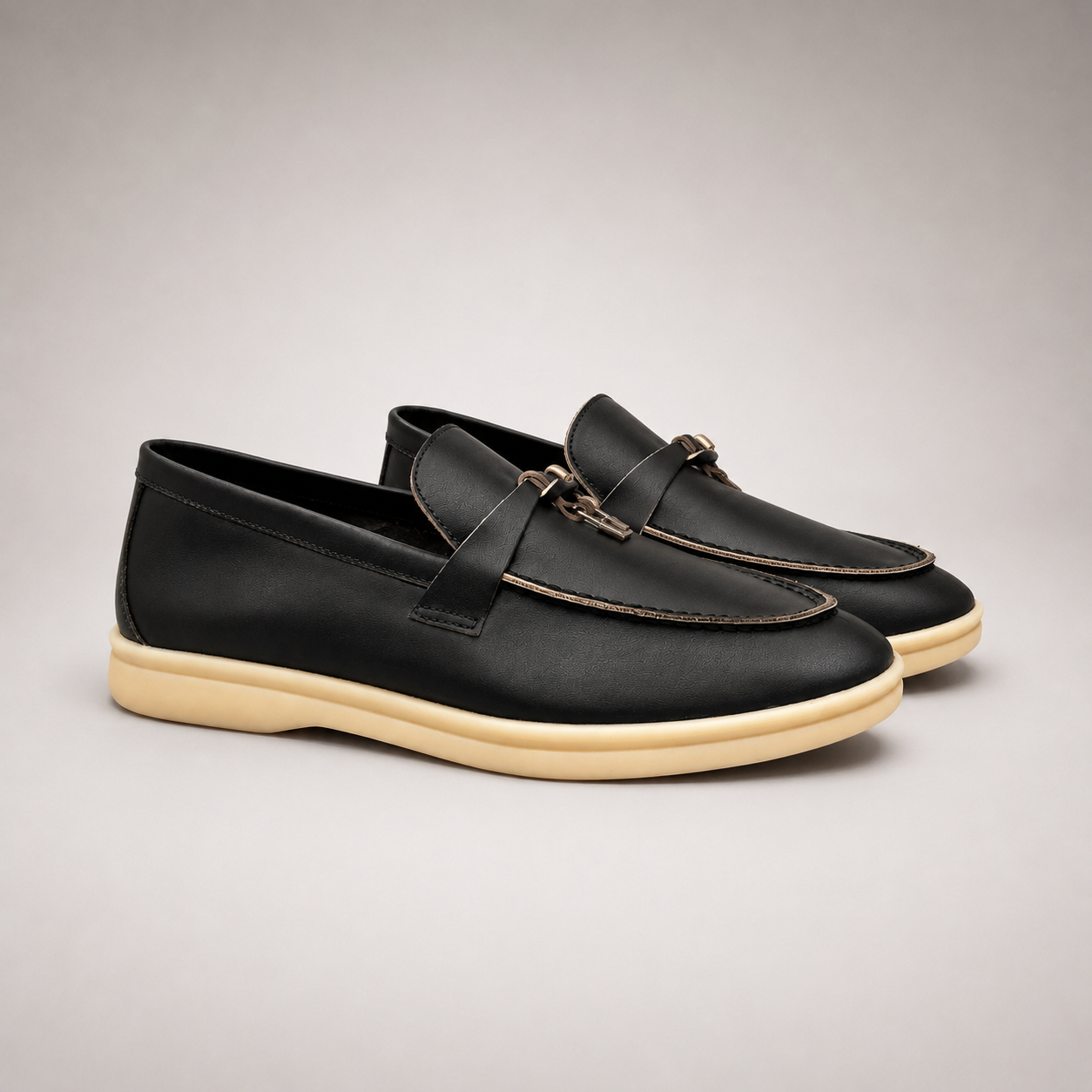 Black loafer second pair angle showing a metal accent across the vamp