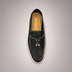 Black loafer top view showing a metal accent across the vamp