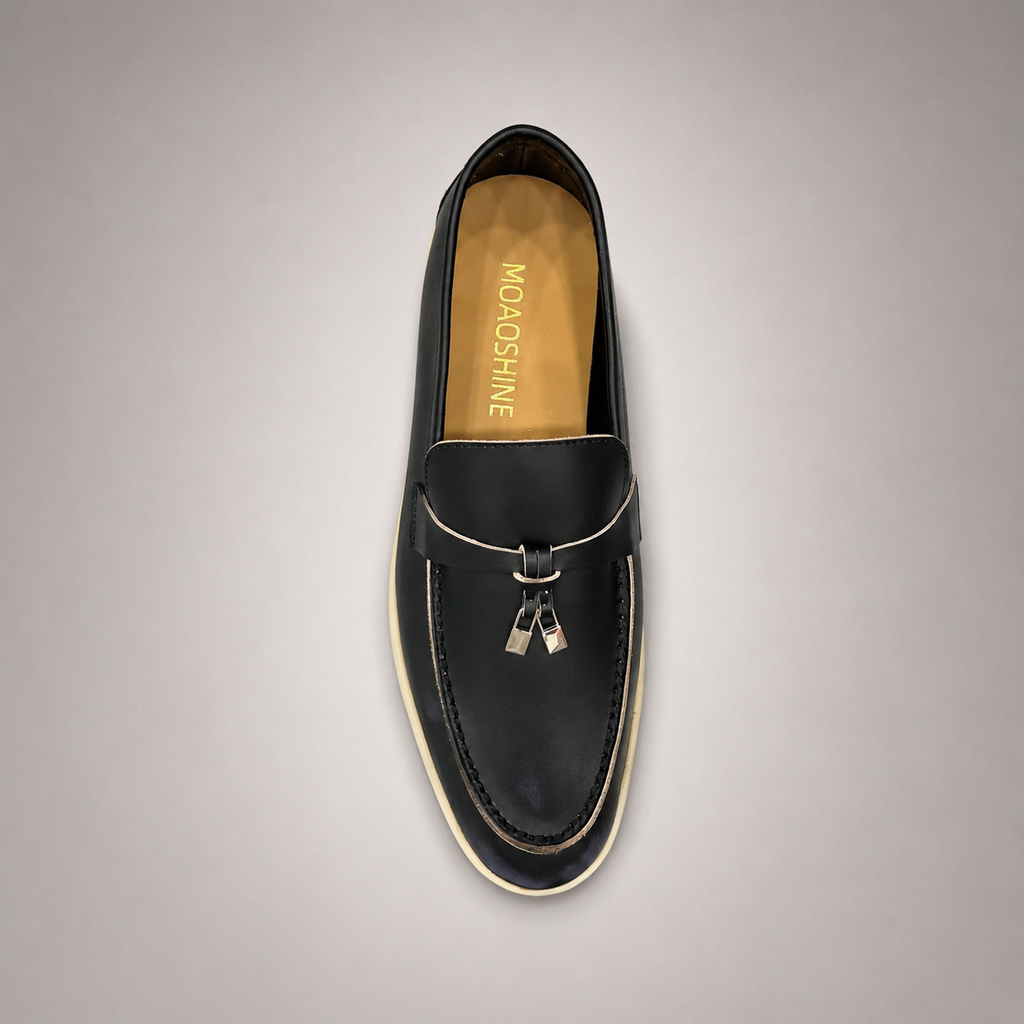 Black loafer top view showing a metal accent across the vamp