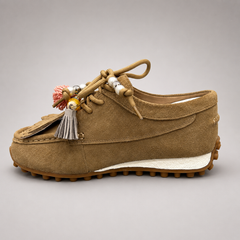 Tan moccasin sneaker opposite side profile showing fringe and tassel details over the laces