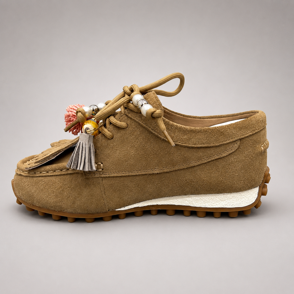Tan moccasin sneaker opposite side profile showing fringe and tassel details over the laces