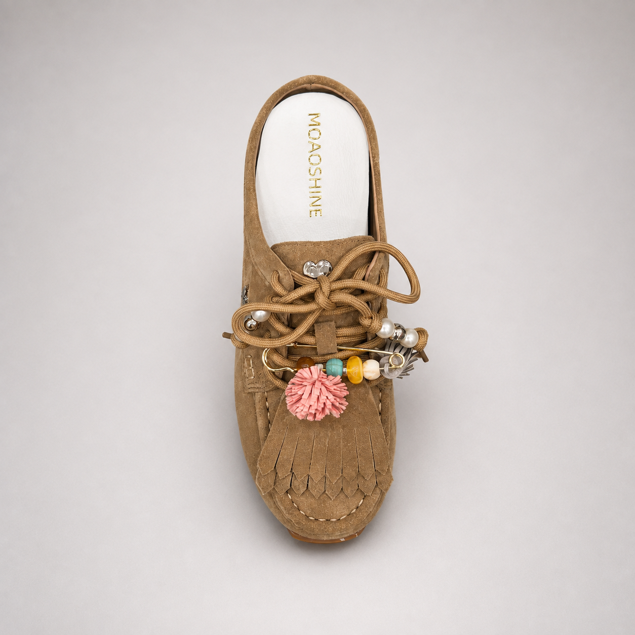 Tan moccasin sneaker outsole view showing the rubber outsole