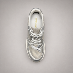 Silver sneaker top view showing a panelled lace-up upper
