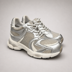 Silver sneaker pair three-quarter view showing a panelled lace-up upper