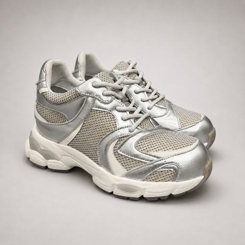 Silver sneaker pair three-quarter view showing a panelled lace-up upper