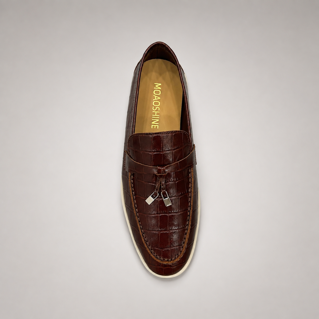 Brown loafer top view showing a crocodile-pattern embossed upper and vamp strap