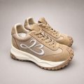 Beige sneaker pair three-quarter view showing a panelled lace-up upper