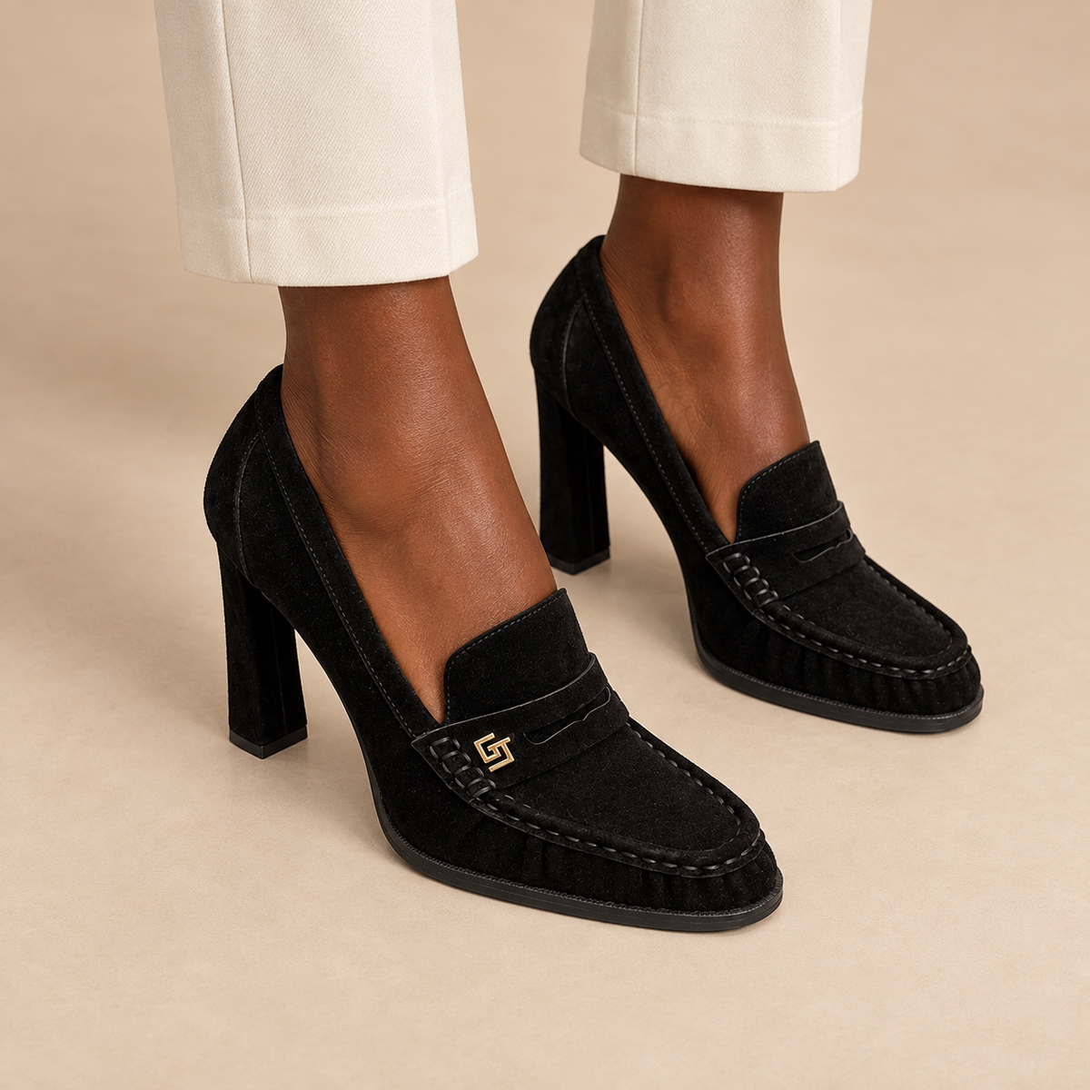 Black suede block-heel high-heeled loafers worn with ivory trousers