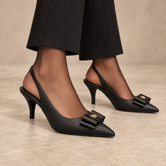 Black pointed-toe bow-ornament slingback pumps worn with black trousers