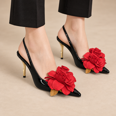 Black patent pointed-toe floral-appliqu¨¦ slingback pumps worn with black trousers