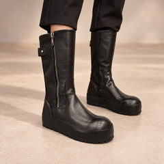 Black water-washed horse leather internal-lift mid-calf boots worn with black trousers