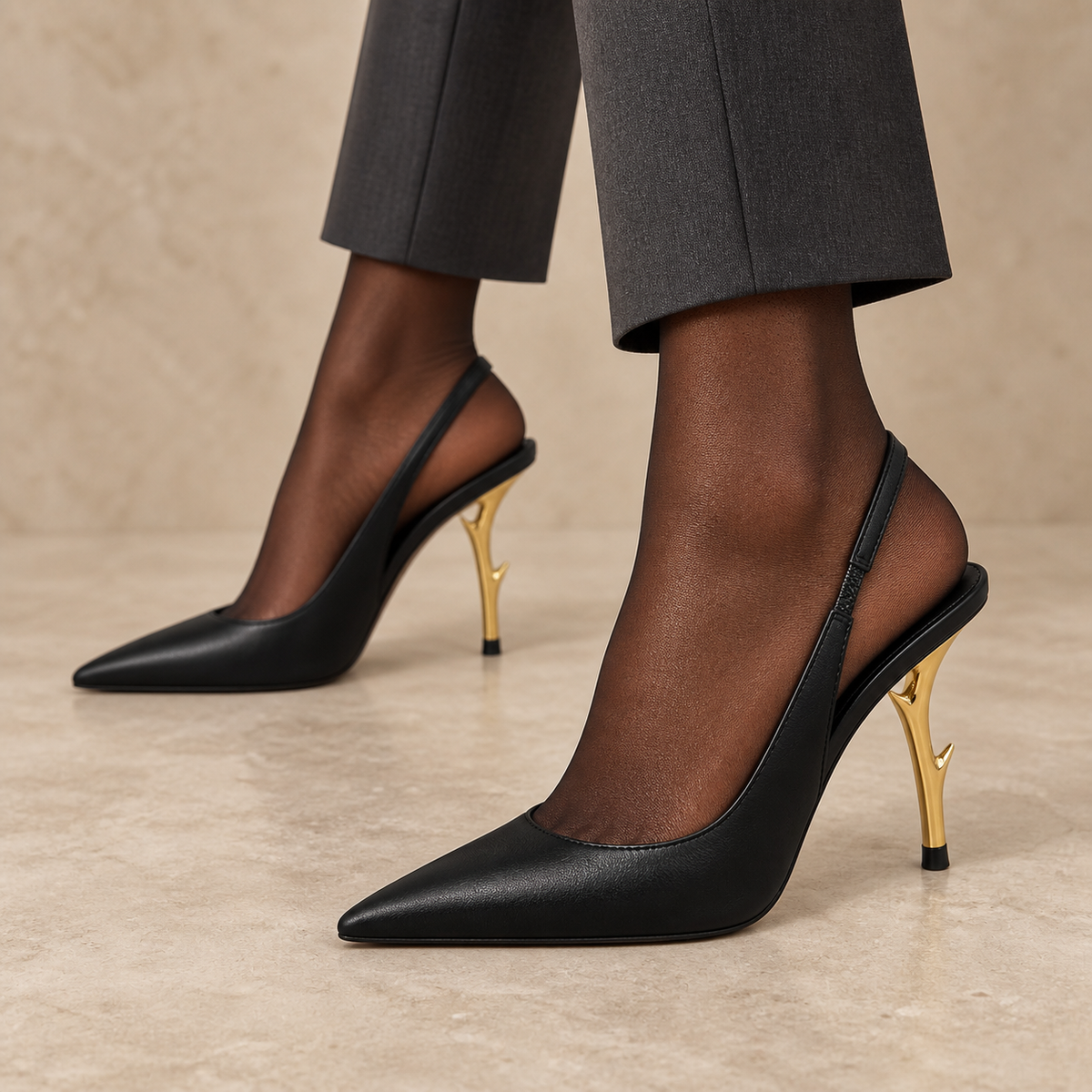 Black sculpted-heel leather slingback pumps worn with charcoal trousers