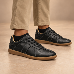 Black water-washed horse leather T-strap block-heel pumps worn with charcoal trousers