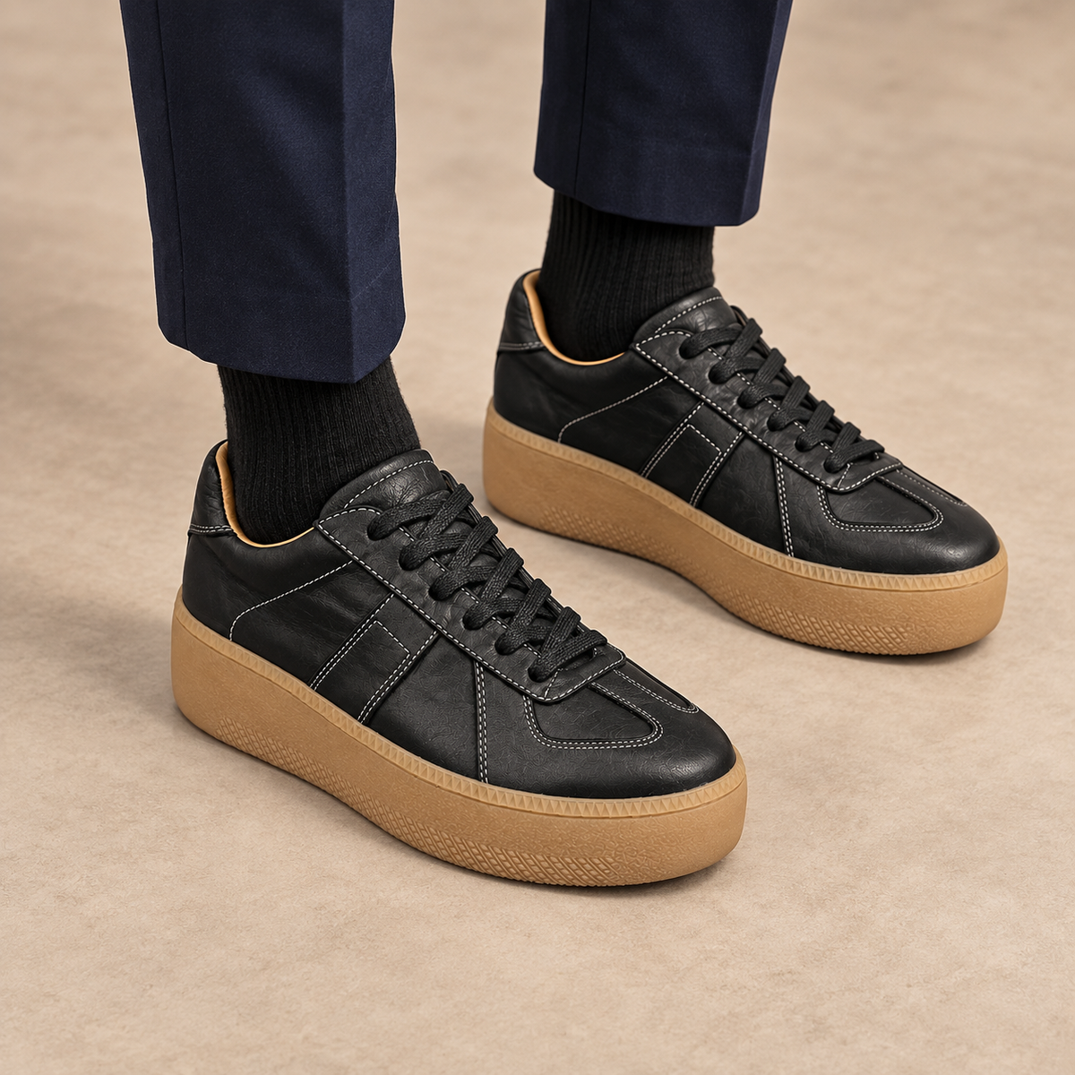 Black washed horse leather platform sneakers worn with navy trousers and black socks