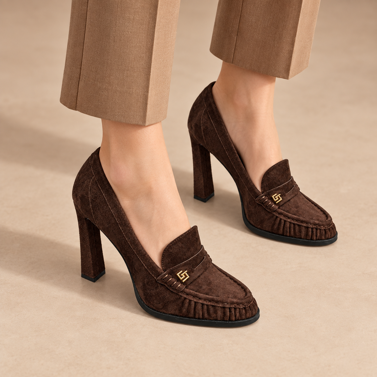 Brown suede block-heel high-heeled loafers worn with tan trousers