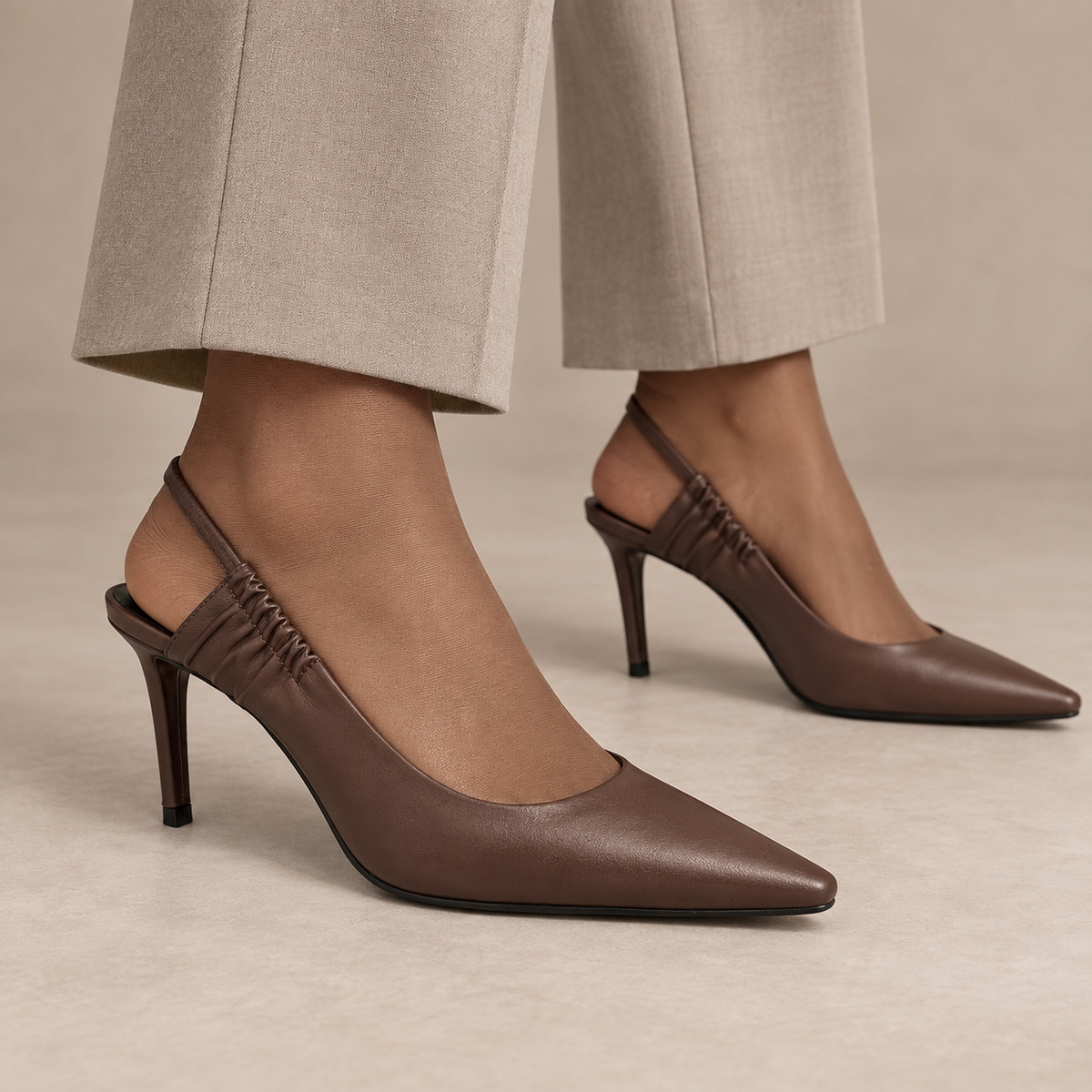 Brown gathered-strap leather slingback pumps worn with stone trousers