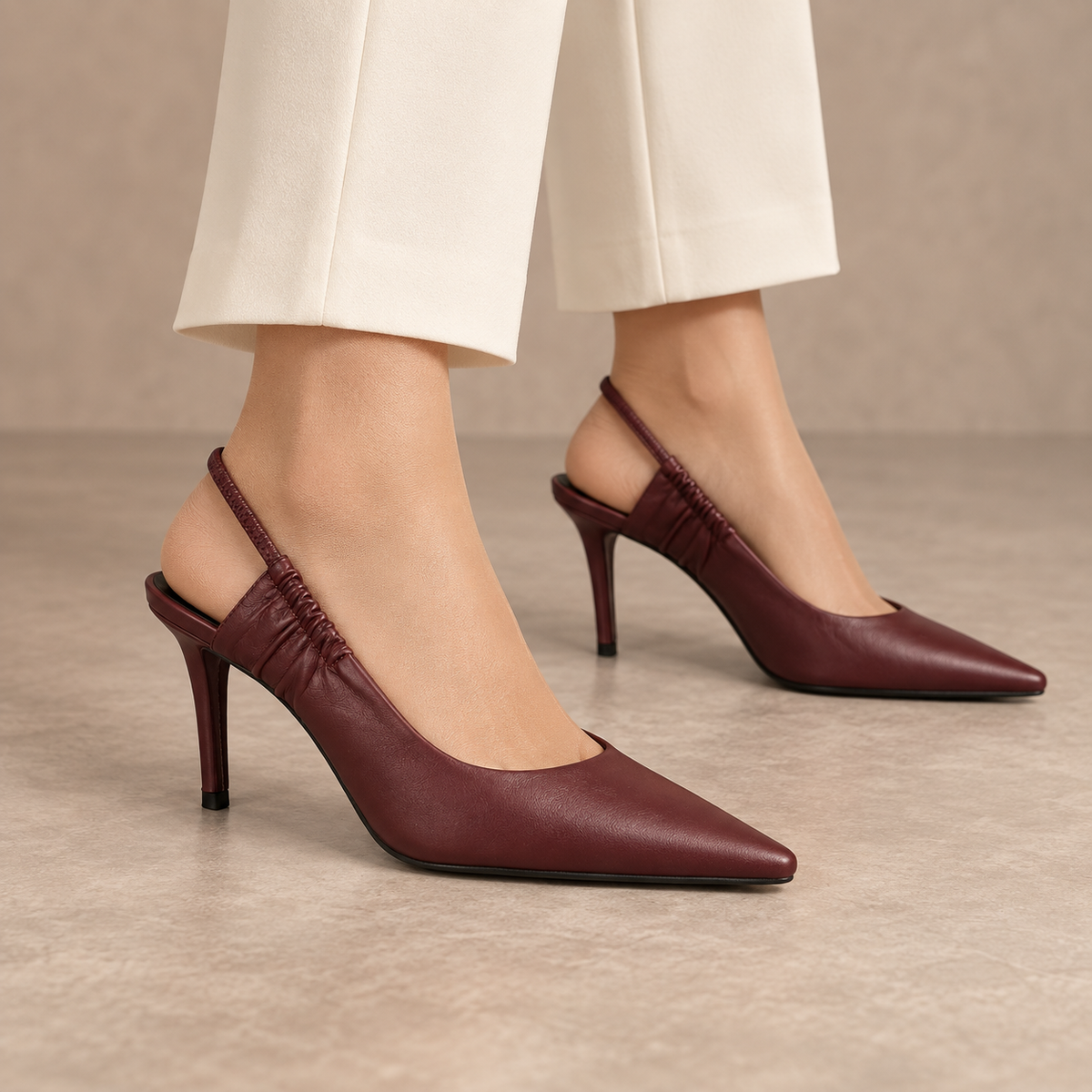 Burgundy gathered-strap leather slingback pumps worn with ivory trousers