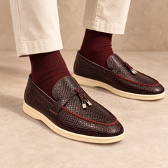 Burgundy snakeskin-embossed tassel loafers worn with cream cropped chinos and burgundy socks
