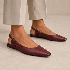 Burgundy square-toe gathered-strap slingback flats worn with stone trousers