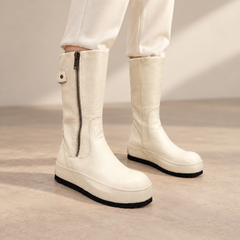 Cream water-washed horse leather internal-lift mid-calf boots worn with ivory trousers