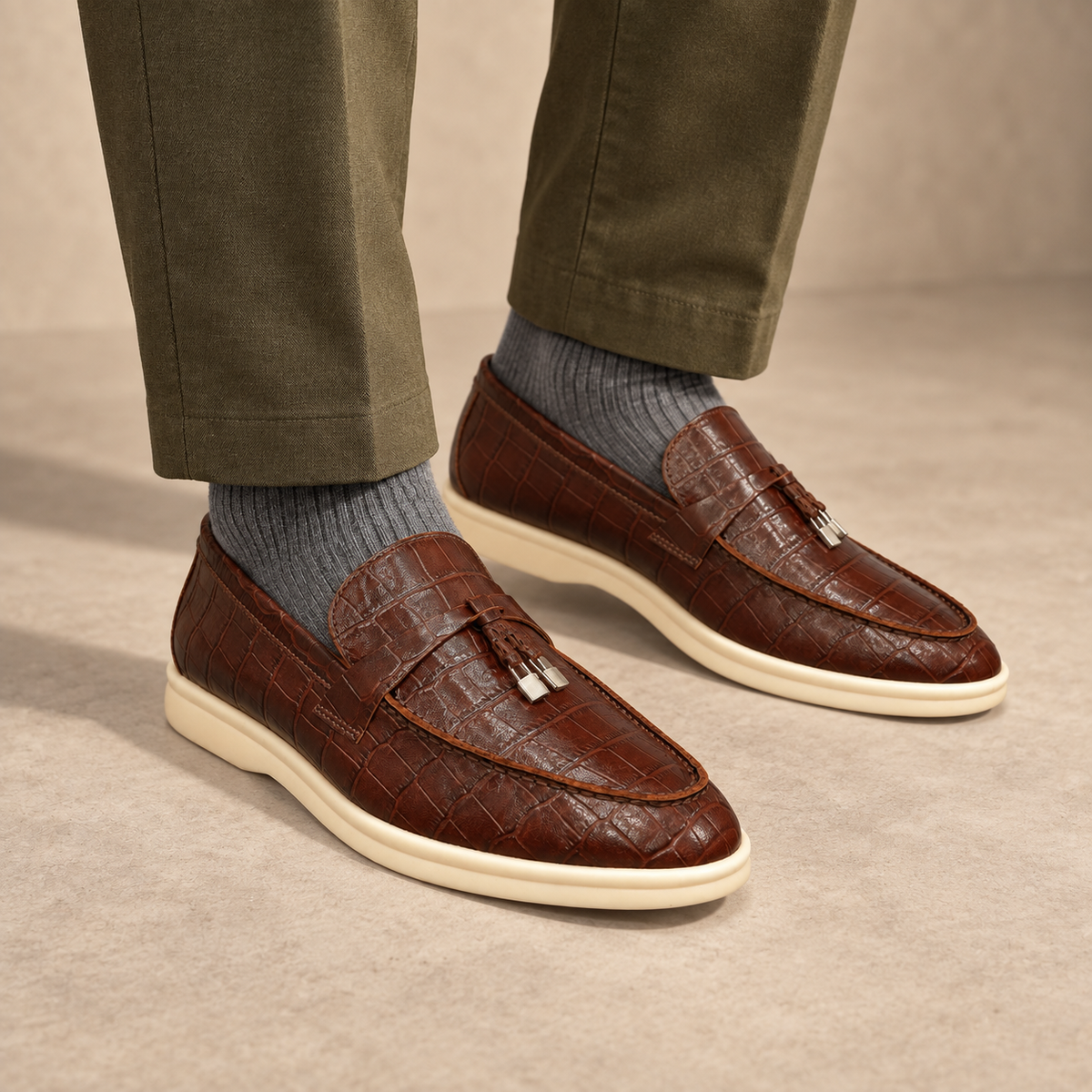 Brown crocodile-embossed strap loafers worn with olive trousers and gray socks