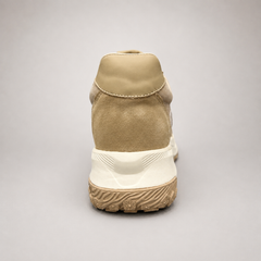 Beige sneaker rear view showing a panelled lace-up upper
