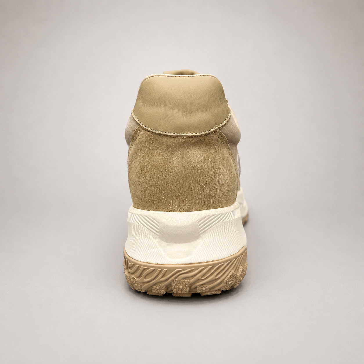 Beige sneaker rear view showing a panelled lace-up upper