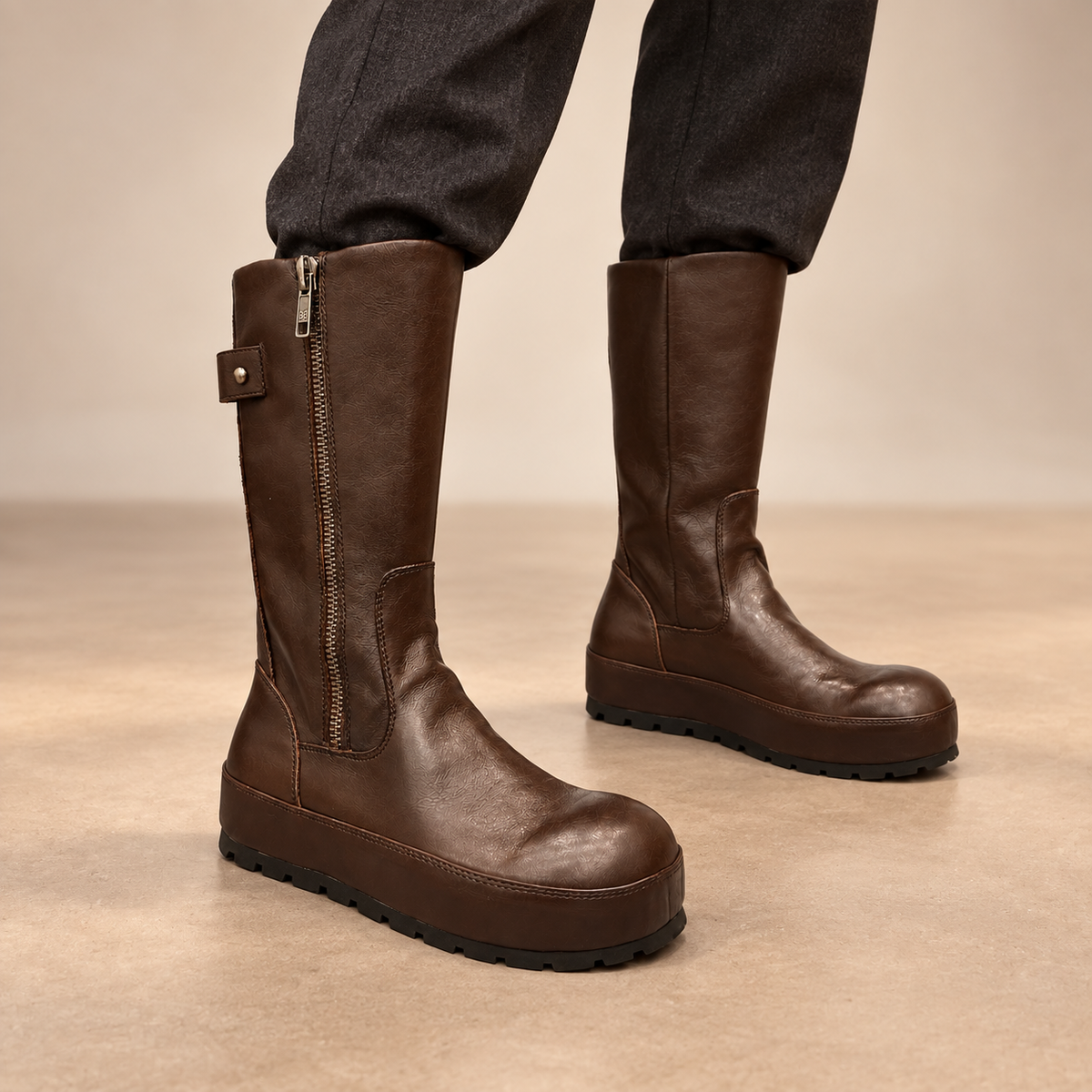 Dark-brown water-washed horse leather internal-lift mid-calf boots worn with charcoal trousers