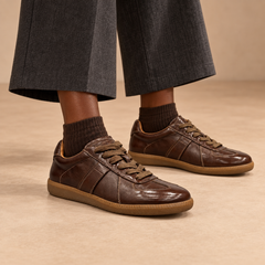 Dark-brown water-washed horse leather lace-up sneakers worn with charcoal trousers and brown socks